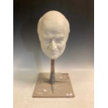 A bust of Sir James Goldsmith by Sc.M.Jennings, dated 2004, plaster on stand, 57cm high