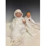 An Armand Marseille, Germany, No 351 bisque head doll, 37cm high, together with a larger Armand