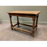 A 17th century and later oak table, the rectangular top raised on turned legs united by stretchers