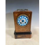 A 19th century French mantle clock, with drum movement encased in an inlaid case with a porcelain