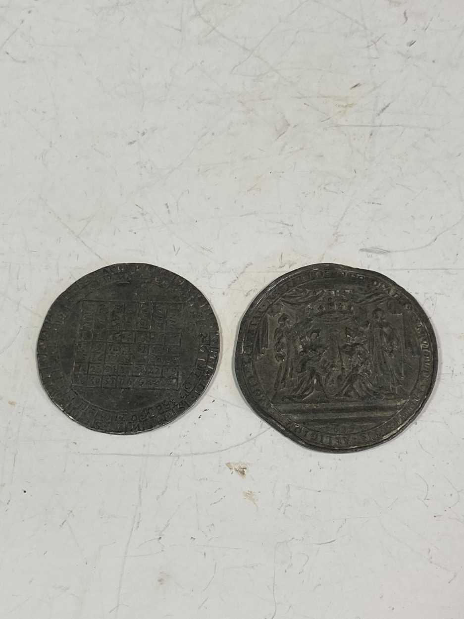 Two late 17th-century pewter commemorative tokens, including an unusual calendar token of 1697 and a
