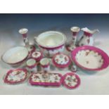 A pink and floral decorated china bedroom set, including dishes and a chamber pot