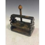 A Victorian stained wood desktop envelope press, with pierced scrolling ends 20 x 20 x 12cm