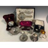 A collection of silverware including flatware, egg cups, napkin rings, cased bowl and spoon, pin