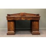 A William IV mahogany sideboard,the shaped three quarter gallery back over an inverted breakfront