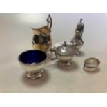 A silver three piece cruet set with blue glass liners, together with a silver napkin ring and a