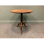 A George III mahogany tripod table, the circular tilt-top above a turned column support raised on