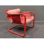 A red tubular armchair, a tubular chromed coffee table, a Vansen side table and another