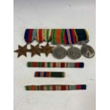 A set of WWII medals, the George VI with Territorial suspender bar '2050496 GNR. R.H.WEST. R.A',