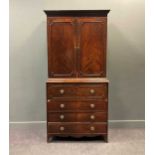 An early 19th century mahogany secretaire cabinet, the dental moulded cornice over pair of
