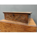 An 18th century oak bible box, the hinged top above a carved front panel, 21 x 64 x 44cm