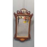 A Regency mahogany fret framed wall mirror, decorated with a carved gilt phoenix above a shell