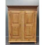 A French 19th century pine wardrobe, the moulded cornice above pair of panelled doors over two
