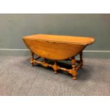 An Ercol drop leaf coffee table, 49x 107 x 94cm