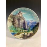 A large Theodore Deck charger decorated with figures in a mountainous landscape, stapled, 50cm