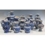 Various Westerwald moulded blue and grey milk jugs; together with a two-handled vase; A collection
