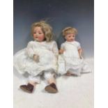 A Kammer & Reinhardt bisque head doll made by Simon & Halbig No 128, 54cm high, together with a
