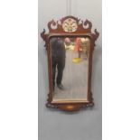 A George III mahogany fret framed wall mirror, decorated with a pierced gilt scallop and an inlaid