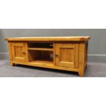 A low oak side cabinet with cupboard doors flanking a central recess, 49.5 x 134 x 44cm