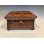 An early 19th century flame mahogany sarcophogus shaped tea caddy with bead moulded edge, 21 x 35