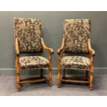 A pair of William and Mary style walnut armchairs, the rectangular backs and seats upholstered in