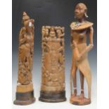 Two modern Thai figures and a carved wooden figure within a landscape, tallest 61cm high (3)