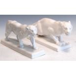 A Berlin porcelain white glazed model of a tiger and another white glazed model of a tiger 19 x 35 x