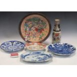Three blue and white Chinese plates decorated with flowers and blossoms; together with a vase and