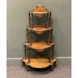 A Victorian walnut and part ebonised whatnot, the four shaped tiers raised on turned supports 123.