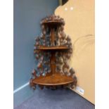 A Continental 19th century walnut three tier hanging corner shelf with gothic form piercing, 78 x 40