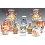 A pair of Japanese Kutani vases with a dog of Pho handles, the baluster bodies with landscapes,