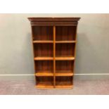An oak open bookcase with curved sides, 140.5 x 92 x 27cm