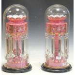 A pair of pink glass table lustres with floral decoration and hung with prismatic drops 38cm,