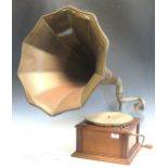 An early 20th century Cinch Zonophone, in an oak case with winding handle and copper horn; a 1930'