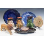 A Wooden model of a lion, a pottery leaf-shaped dish,a blue glazed plate incised with leaves, a