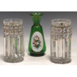 A pair of candle lustre candlesticks, 19cm high, and a 19th century green glass vase, 21cm high (3)