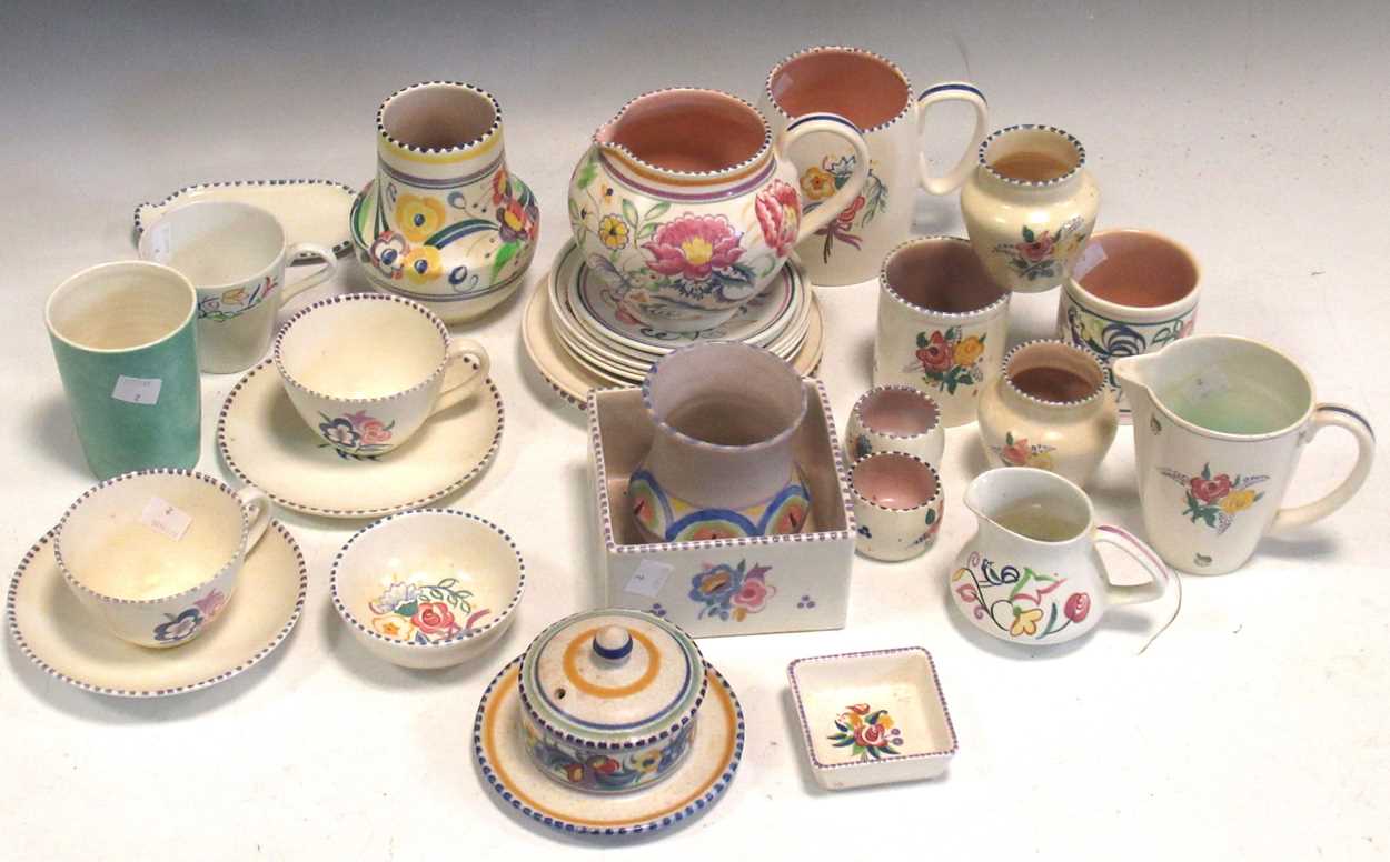 A large collection of Poole Pottery, including teacups, saucers and jugs