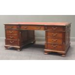 A large Chippendale style mahogany partners desk, with red leather inset writing surface upon