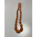 An amber bead necklace, weight 57.4gOverall condition: GoodNoticeable blemishes in all beadsString