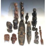 A collection of various African hardwood carvings, to include figures and masks
