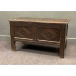 An early 18th century oak coffer chest with carved front on stile feet, 65 x 115 x 46cm
