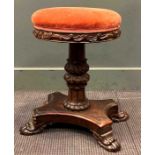 An early Victorian carved rosewood piano stool on paw feet, 55 x 45 x 33cmProvenance:Collection of