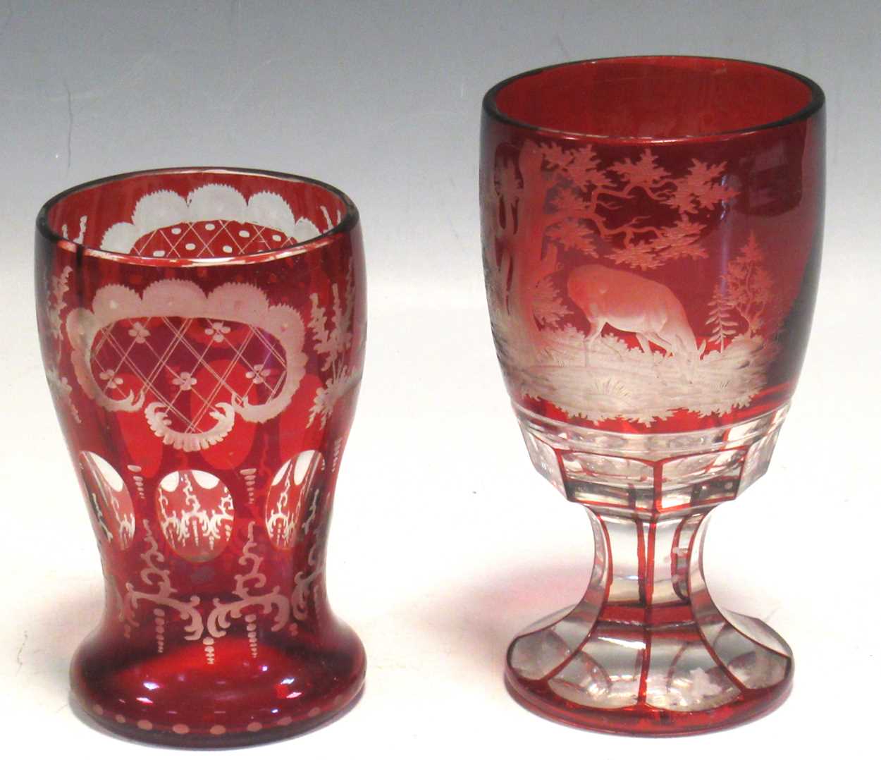 A 19th century Bohemian red cameo glass engraved with deer; together with another, tallest 15cm