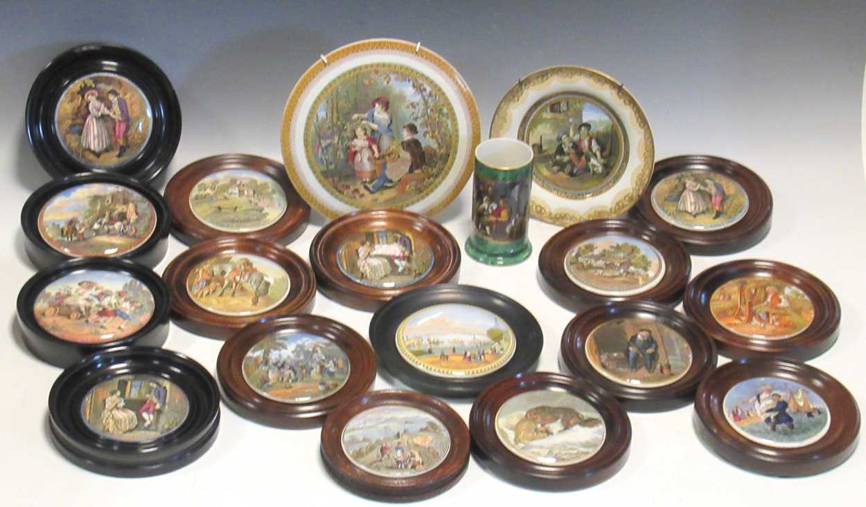 A collection of Victorian and later ceramic pot lids presented as wall plaques with wooden