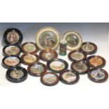 A collection of Victorian and later ceramic pot lids presented as wall plaques with wooden