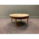 An Empire style marble top coffee table, early 20th century, the circular top with pierced brass