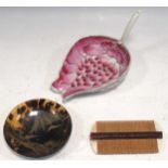 A Chinese porcelain lotus libation cup, a hair comb and a tortoiseshell dish, circa 1890 (3)