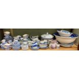 A large collection of blue and white transfer printed wares together with some commemorative mugs