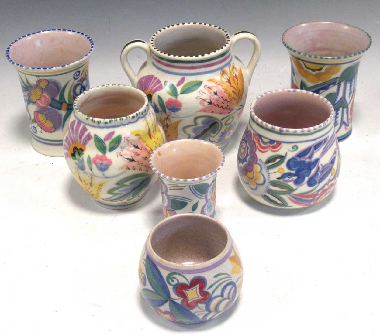 Seven Poole Pottery vases, one with two handles, tallest 13cm high (7)