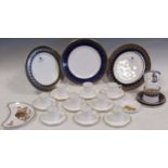 A Royal Worcester plate, side plate and coffee cup and saucer, decorated with blue and gilt borders,